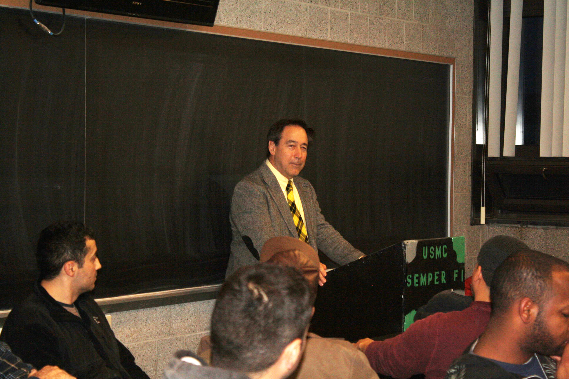 James Kernan speaking to a room of trainees at a USMC Semper Fidelis podium