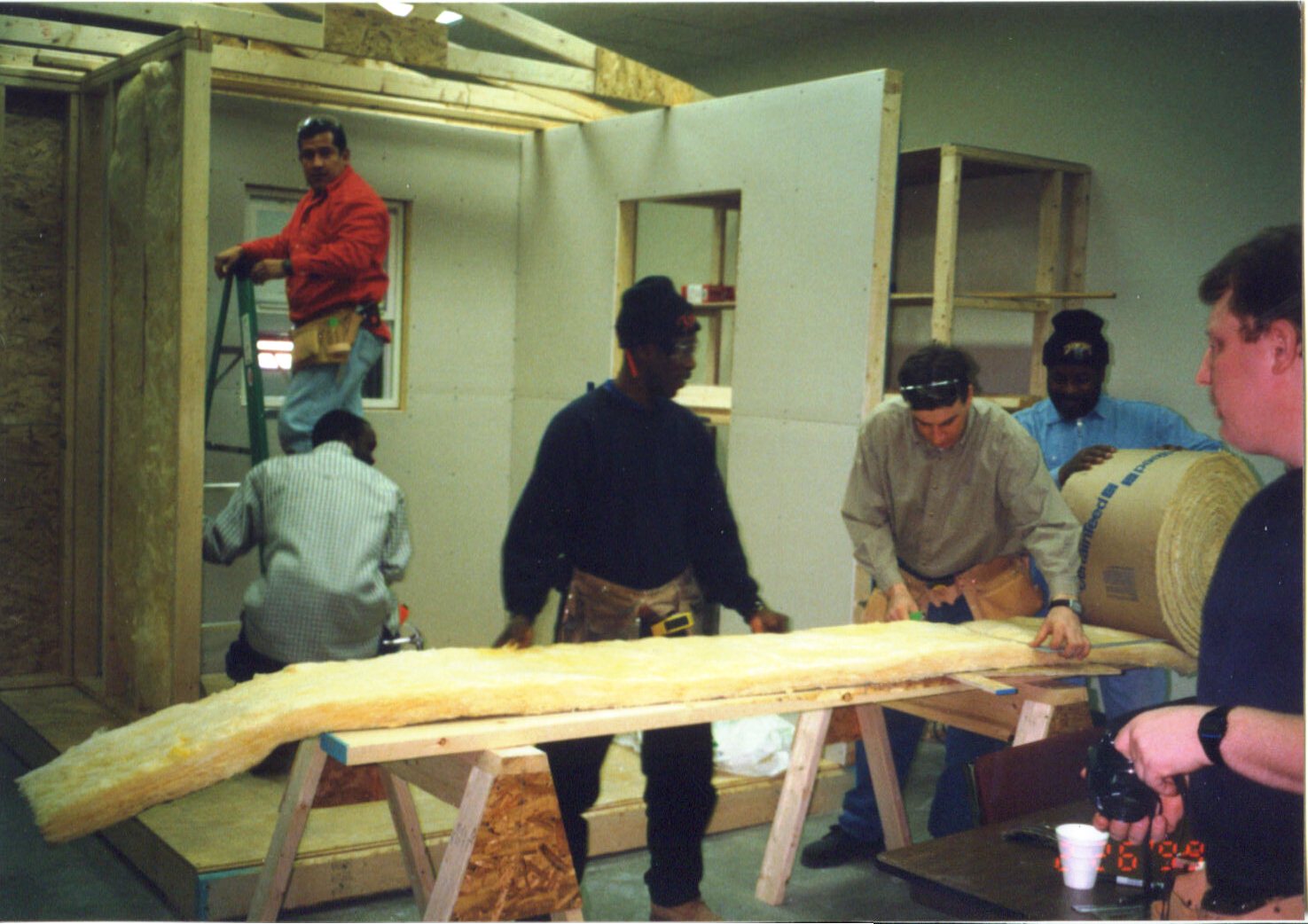 Apprentices framing and insulating a training mock-up in one of James Kernan's registered on-the-job training programs